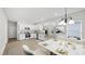 Modern kitchen with stainless steel appliances, white cabinets, and a marble countertop dining table at 2305 Pinecroft Dv, Burlington, NC 27217
