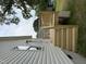 A new, unfinished backyard deck and stairs against a home with white siding and mature trees at 2309 Pinecroft Dr, Burlington, NC 27217