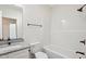 Bright bathroom featuring a shower-tub combo, granite vanity, and a clean, modern design at 2309 Pinecroft Dr, Burlington, NC 27217