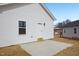 Side of home with concrete patio and back entrance showing the white siding at 2309 Pinecroft Dr, Burlington, NC 27217