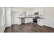 Modern kitchen featuring stainless appliances, granite counters, white cabinets and sleek hardwood flooring at 2309 Pinecroft Dr, Burlington, NC 27217