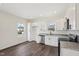 Modern kitchen featuring stainless appliances, granite counters, white cabinets and sleek hardwood flooring at 2309 Pinecroft Dr, Burlington, NC 27217