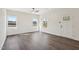 Bright living room featuring vinyl flooring, large windows, and a modern ceiling fan at 2309 Pinecroft Dr, Burlington, NC 27217