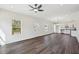 Bright, open-concept living room features dark wood floors, modern ceiling fan and lots of natural light at 2309 Pinecroft Dr, Burlington, NC 27217