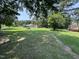Expansive backyard with lush green grass, mature trees, and a cozy outbuilding, perfect for outdoor enjoyment at 2433 Zacks Mill Rd, Angier, NC 27501
