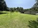 Spacious backyard featuring a volleyball net, well-maintained lawn, and an outbuilding, ideal for recreational activities at 2433 Zacks Mill Rd, Angier, NC 27501