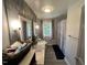 Bathroom featuring dual marble top vanities, wood accent wall and tub shower at 2433 Zacks Mill Rd, Angier, NC 27501