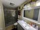 Bathroom featuring a tiled shower, sunflower accents and a single sink at 2433 Zacks Mill Rd, Angier, NC 27501