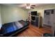 Bedroom featuring hardwood floors and a television set at 2433 Zacks Mill Rd, Angier, NC 27501