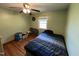 Bright bedroom with hardwood floors, ceiling fan, and a window with natural light at 2433 Zacks Mill Rd, Angier, NC 27501