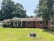 Charming single story brick home with a well-manicured lawn, covered porch, and classic architectural details at 2433 Zacks Mill Rd, Angier, NC 27501