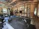 Home gym with a variety of exercise equipment, including weights, punching bag, and pull-up bar, for fitness enthusiasts at 2433 Zacks Mill Rd, Angier, NC 27501