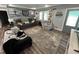 Cozy living room features a textured accent wall, plush seating, and ample natural light at 2433 Zacks Mill Rd, Angier, NC 27501