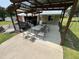 Outdoor covered patio with ample seating, a grill, and an open design, perfect for gatherings and relaxing at 2433 Zacks Mill Rd, Angier, NC 27501