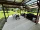 Outdoor covered patio with a dining set and grill, perfect for entertaining and enjoying outdoor meals at 2433 Zacks Mill Rd, Angier, NC 27501