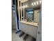Bathroom with double sink vanity, large mirror, and decorative black and white striped wall at 2452 Bay Harbor Dr, Raleigh, NC 27604