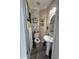 Cozy half bathroom with pedestal sink and decorative wallpaper at 2452 Bay Harbor Dr, Raleigh, NC 27604