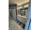 Bathroom with double sink vanity, large mirror, and decorative black and white striped wall at 2452 Bay Harbor Dr, Raleigh, NC 27604