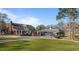 Stately brick home on a golf course featuring manicured landscaping and covered porches at 2452 Bay Harbor Dr, Raleigh, NC 27604