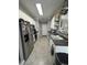 Functional galley kitchen with stainless steel appliances, white cabinets, and easy access to the dining area at 2452 Bay Harbor Dr, Raleigh, NC 27604