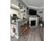 Open-concept kitchen with a breakfast bar and stools flowing into a living area with a fireplace at 2452 Bay Harbor Dr, Raleigh, NC 27604