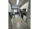 Efficient kitchen with white cabinets, dark countertops, and stainless steel appliances, open to dining area at 2452 Bay Harbor Dr, Raleigh, NC 27604