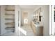Bathroom featuring marble floors, dual sink vanities with lighted mirrors and modern fixtures at 249 Mollie Meadow Dr, Zebulon, NC 27597