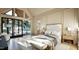 Bright bedroom with hardwood floors, large windows, and sliding door access to outdoor seating at 249 Mollie Meadow Dr, Zebulon, NC 27597