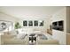 Bright and airy living room featuring a large sectional, arm chairs, and an entertainment center at 249 Mollie Meadow Dr, Zebulon, NC 27597