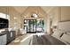 Bright primary bedroom with high ceilings, a sleek dresser, and access to an outdoor seating area at 249 Mollie Meadow Dr, Zebulon, NC 27597