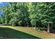 Expansive backyard featuring a well-manicured lawn, mature trees, and privacy at 267 Ashley Woods Ct, Clayton, NC 27527