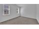 This bedroom features neutral carpet, white walls, and two windows with blinds at 267 Ashley Woods Ct, Clayton, NC 27527