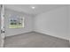 Bright, empty bedroom with carpet and a large window at 267 Ashley Woods Ct, Clayton, NC 27527