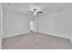 This bedroom features neutral carpet, white walls, and a ceiling fan at 267 Ashley Woods Ct, Clayton, NC 27527