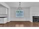 Bright dining area featuring a chandelier, wood floors, wainscoting, and a fireplace at 267 Ashley Woods Ct, Clayton, NC 27527