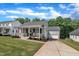 Attractive home with covered front porch, American flag and well-maintained lawn and landscape at 267 Ashley Woods Ct, Clayton, NC 27527