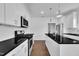 Kitchen featuring stainless steel appliances, granite countertops, white cabinetry, and wooden floors at 267 Ashley Woods Ct, Clayton, NC 27527