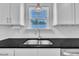 Kitchen sink area featuring stainless steel sink, granite countertops, and white cabinetry at 267 Ashley Woods Ct, Clayton, NC 27527