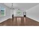 Large open concept living area with wood floors, fireplace, and an elegant chandelier at 267 Ashley Woods Ct, Clayton, NC 27527