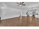 Expansive living area with wood floors, a ceiling fan, and seamless flow into the kitchen at 267 Ashley Woods Ct, Clayton, NC 27527