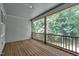 Cozy screened-in porch with wood flooring and views of the wooded backyard at 267 Ashley Woods Ct, Clayton, NC 27527