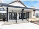 Inviting clubhouse entrance with a covered porch, black accents, and stone detailing at 287 Aspen Ave, Pittsboro, NC 27312