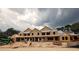 New construction of townhomes with wood framing and dark storm clouds above at 2930 Alyssa Ct, Knightdale, NC 27604