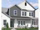 Charming two-story home with a welcoming front porch, green door and well-manicured lawn at 2930 Alyssa Ct, Knightdale, NC 27604