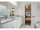 Well-lit bathroom featuring double sinks, granite countertops, and modern fixtures at 3020 Woods Walk Way, Rocky Mount, NC 27804