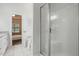 Bright bathroom featuring a glass shower, soaking tub, and access to the primary bedroom at 3020 Woods Walk Way, Rocky Mount, NC 27804