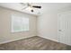 Neutral-toned bedroom with natural light, plush carpet, and a classic ceiling fan at 3020 Woods Walk Way, Rocky Mount, NC 27804