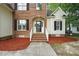 Inviting front entrance with brick steps, white railings, and a decorative arched doorway at 3020 Woods Walk Way, Rocky Mount, NC 27804