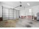 Spacious two-car garage with an opener, featuring white walls, brick accents, and ample room for storage at 3020 Woods Walk Way, Rocky Mount, NC 27804