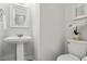 Stylish powder room with modern fixtures, pedestal sink, and elegant decor at 3020 Woods Walk Way, Rocky Mount, NC 27804